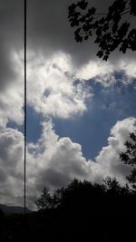 Low angle view of silhouette trees against sky