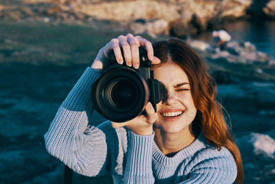 Portrait of woman photographing