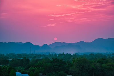 Scenic view of silhouette mountain against romantic sky