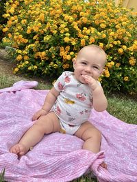 Portrait of cute girl sitting on field