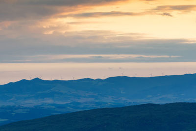 Scenic view of mountains against cloudy sky