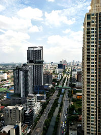 High angle view of street amidst buildings in city against sky