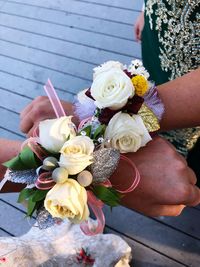 Midsection of woman holding rose bouquet