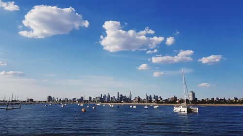 Sailboats sailing in sea against sky