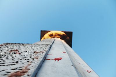 Directly below shot of built structure against clear blue sky