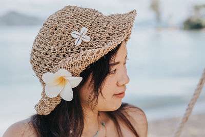 Close-up of woman wearing hat looking away