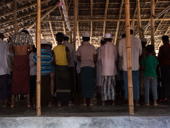 Rear view of men standing in corridor