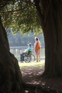 People riding motorcycle on tree trunk