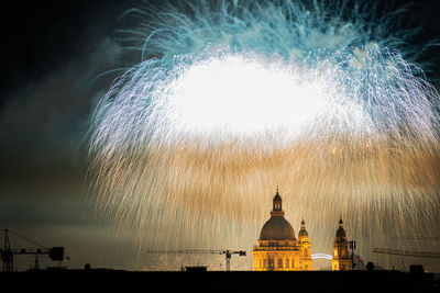 Firework display in city at night