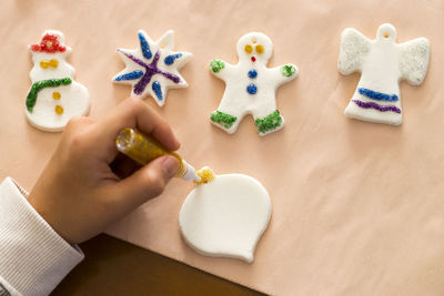 Cropped hand decorating christmas ornaments