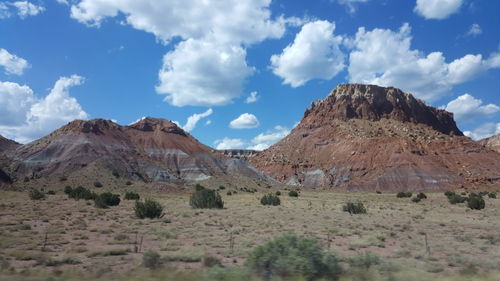 Scenic view of mountains against blue sky