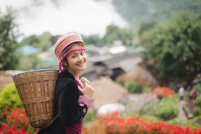 Portrait of smiling woman standing in basket