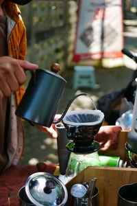 Midsection of man working with coffee