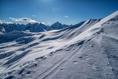 Scenic view of snow covered mountains against sky