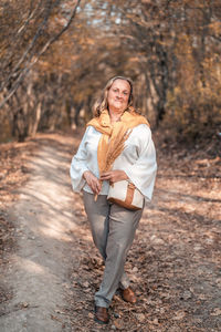 Portrait of a smiling young woman standing outdoors