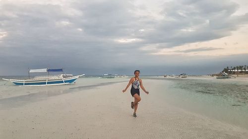 Rear view of young woman on beach