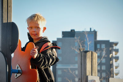 Portrait of boy sitting outdoors