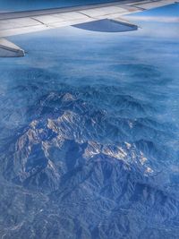 Aerial view of airplane wing over landscape