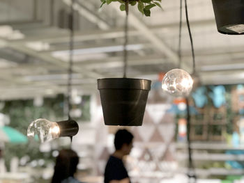 Close-up of electric lamp hanging in cafe