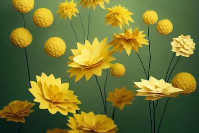 Yellow paper cut flowers on green background. paper bouquet