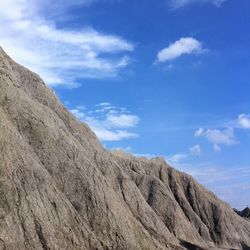 Scenic view of mountains against cloudy sky