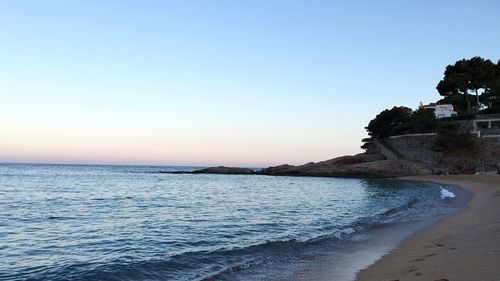 Scenic view of beach against clear sky