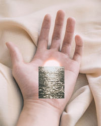 High angle view of person hand holding text