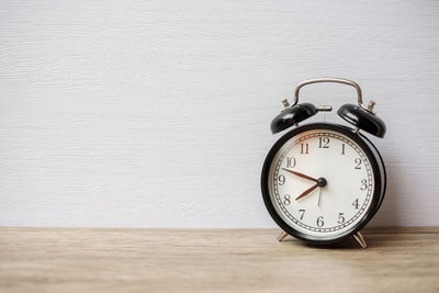 Close-up of clock on table