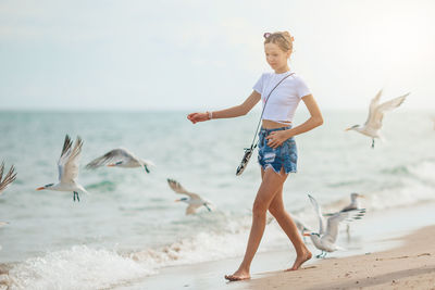 Full length of woman standing on beach