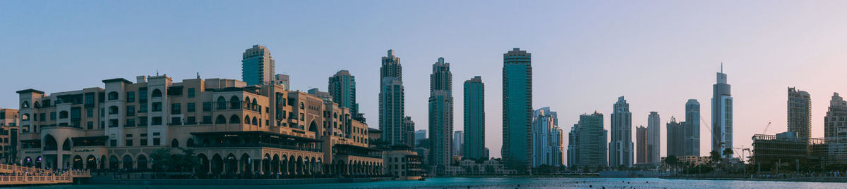 Panoramic view of buildings against clear sky in city