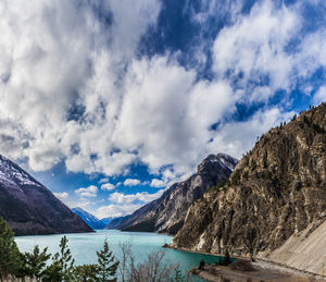 Scenic view of lake and mountains against blue sky