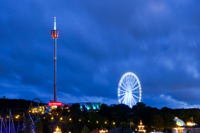 Low angle view of illuminated ferris wheel against sky at night