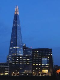 Low angle view of illuminated buildings against sky