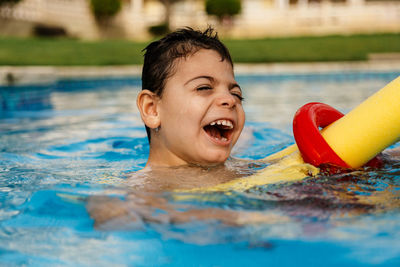 Smiling boy swimming in pool