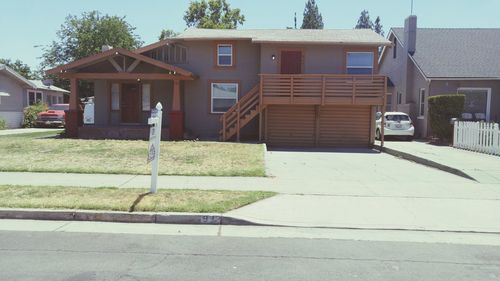 Houses by street against buildings in city