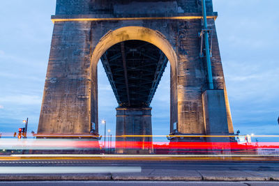 Blurred motion of light trails against bridge