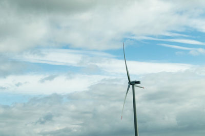 Low angle view of wind turbine against sky