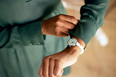 Cropped hand of man holding snail