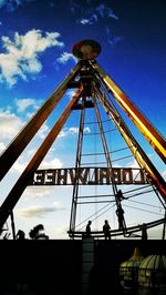 Low angle view of ferris wheel against sky