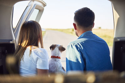 Couple with dog in car