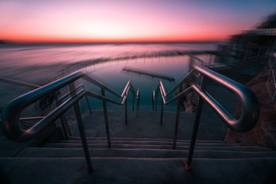 View of metallic structure against sky at sunset