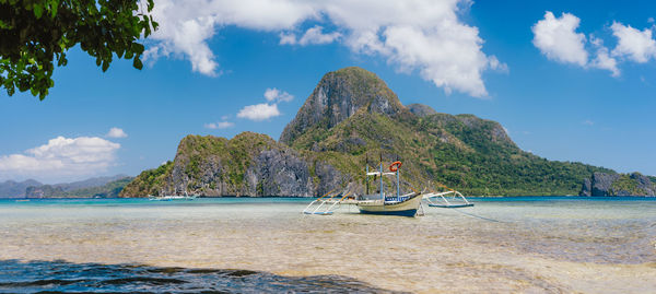 Scenic view of sea and mountains against sky