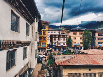 Houses in city against sky