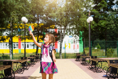 Full length of woman with bubbles in park