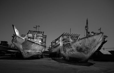 Boats moored at shore against clear sky