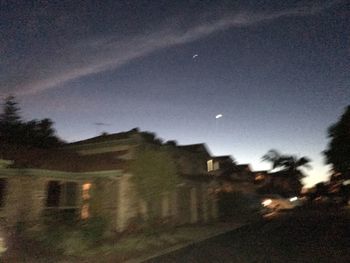 Buildings against sky at night