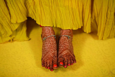 Low section of woman standing on hardwood floor