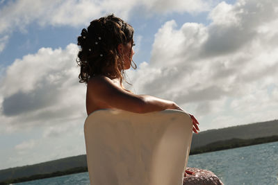 Rear view of woman looking at sea against sky