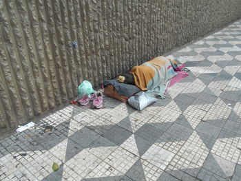 High angle view of baby sleeping on sidewalk