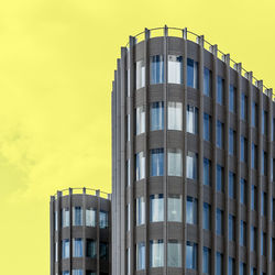 Low angle view of modern building against sky during sunset